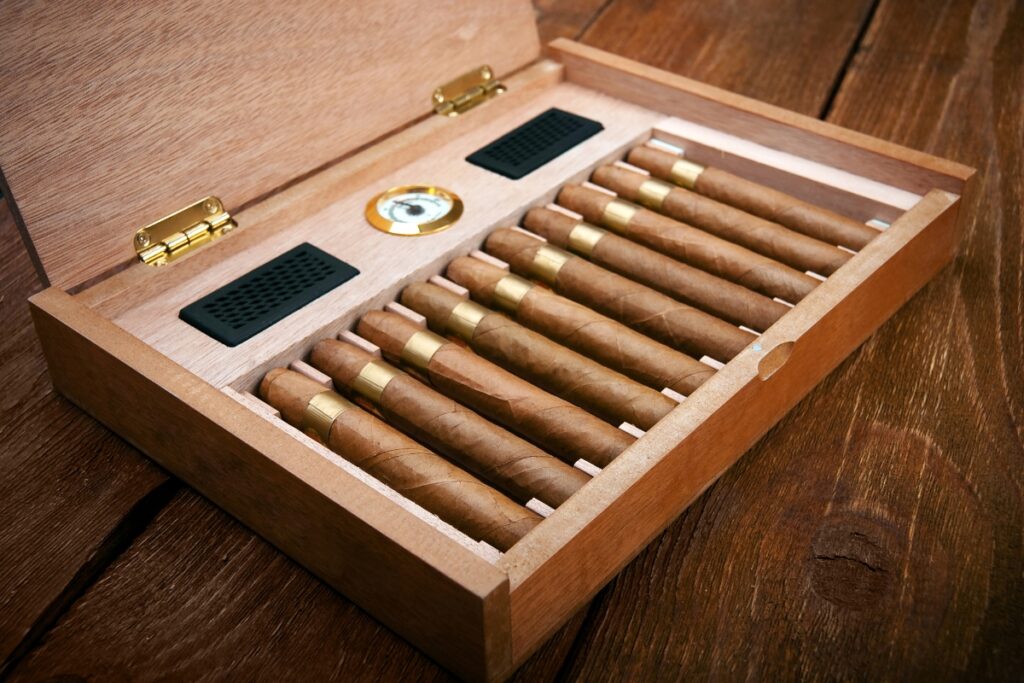 Cigar aficionado's collection of cigars displayed on a wooden table.