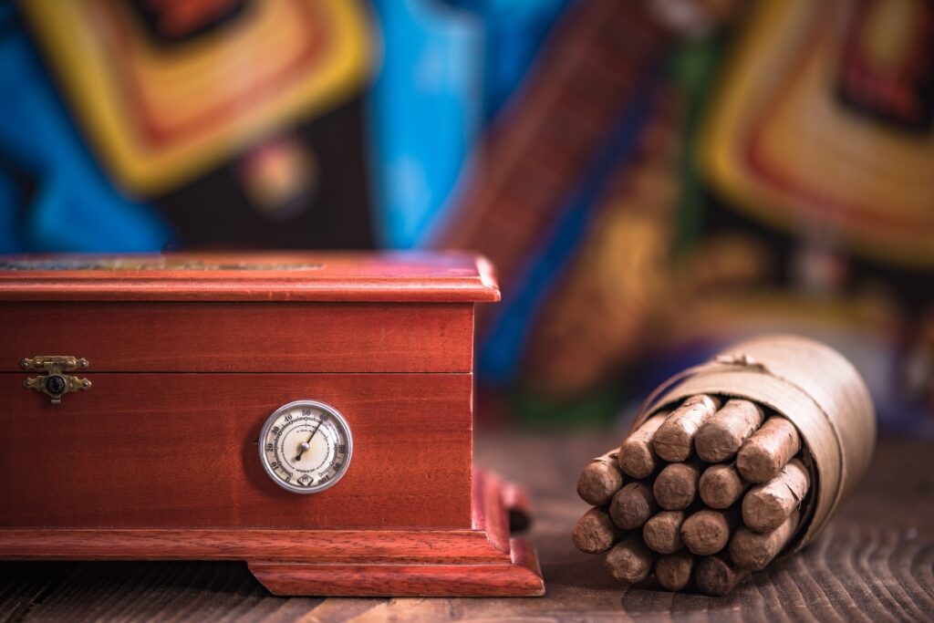 Aging cigars on a wooden table, with a humidor as the perfect companion.