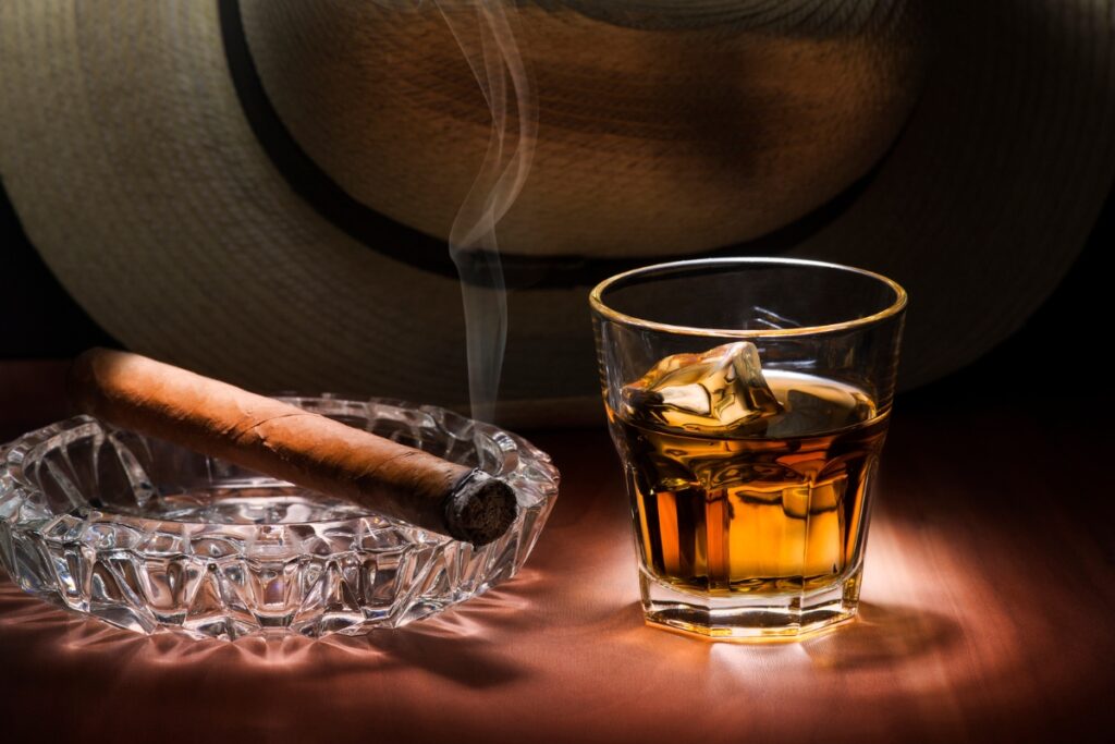 A cigar and a glass of drink pairings.